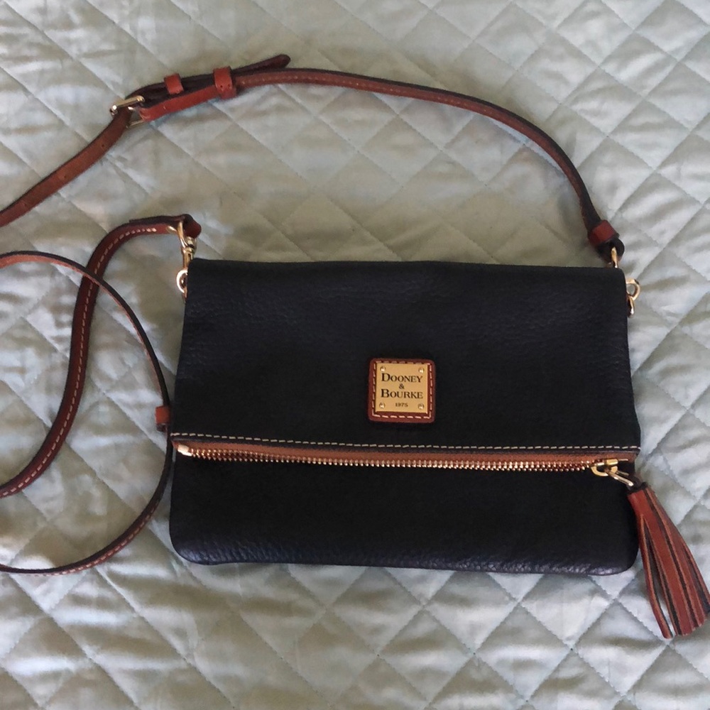 Dooney & Bourke fold over crossbody in black pebble leather with red interior
